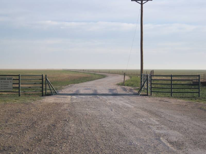 Steel pipe ranch entrance gates on a gravel road