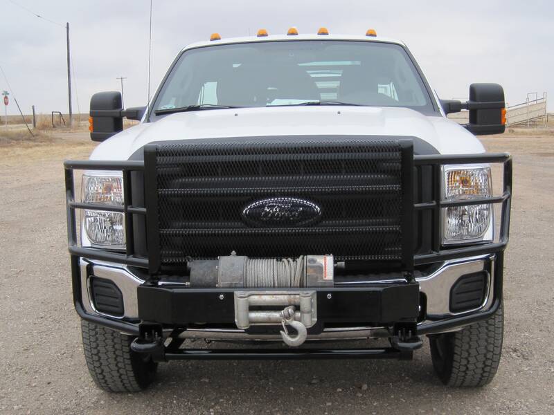 Black grill guard with winch on a white pickup